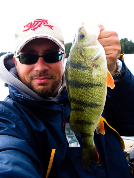 Angler mit Barsch auf Belly Boat