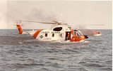 800px-HH-3F_Pelican_on_the_water_with_a_burning_boat.jpg